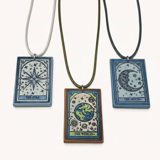 DTB Alchemy trio of handmade matte polymer clay tarot card necklaces featuring The Star, The World, and The Moon.